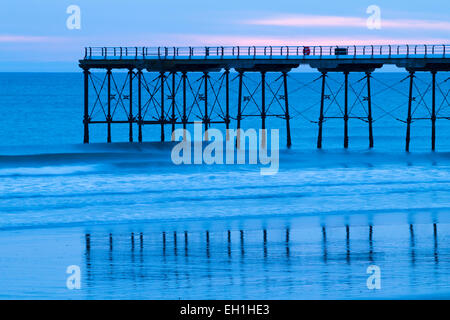 Saltburn by the sea, UK. 5th March, 2015. UK Weather: Saltburn`s Victorian pier at sunrise with a touch of red sky on the horizon.  Temperatures are forecast to rise towards the weekend. Credit:  ALANDAWSONPHOTOGRAPHY/Alamy Live News Stock Photo
